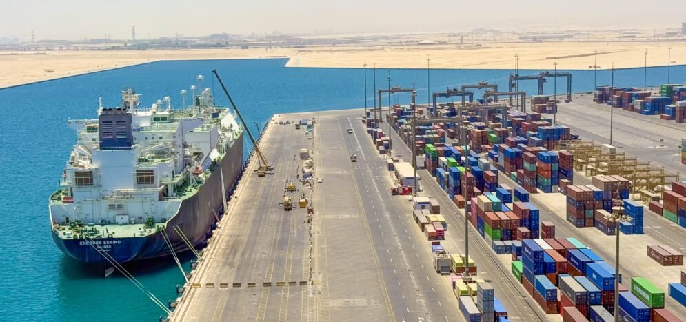 Container vessel at a commercial port representing shipping machinery, furniture, and goods from Italy to Egypt.